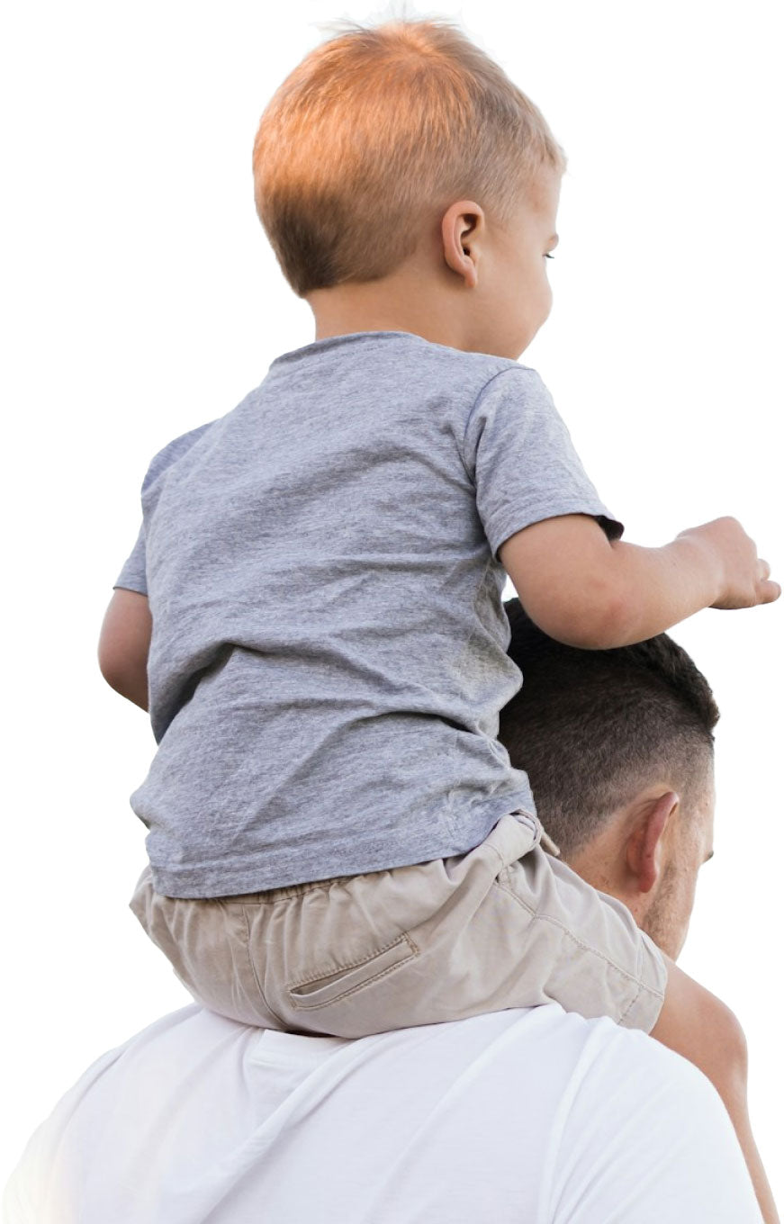 Young child on his father's shoulders, experiencing the joy of fatherhood, against a clear sky background